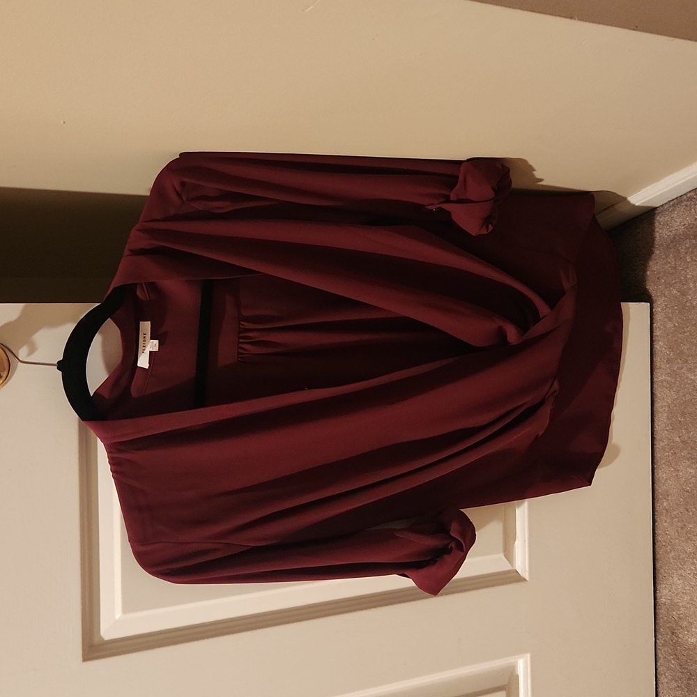 Wrap blouse with front button closure.